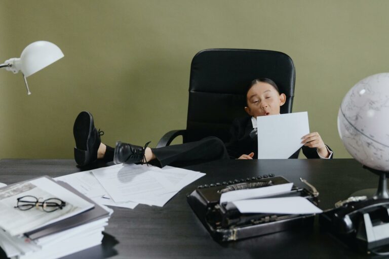 girl sitting on office chair holding white paper